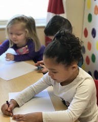 Children drawing at a table