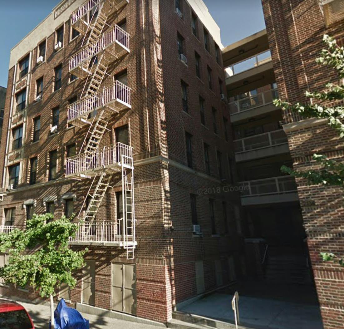 Brick building with multiple fire escapes on the side