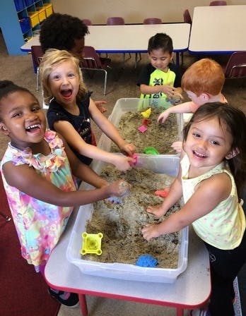 Children playing in sand tables