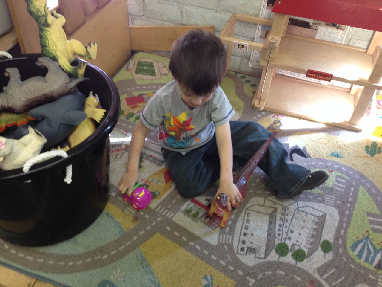 Child playing with toys on a rug