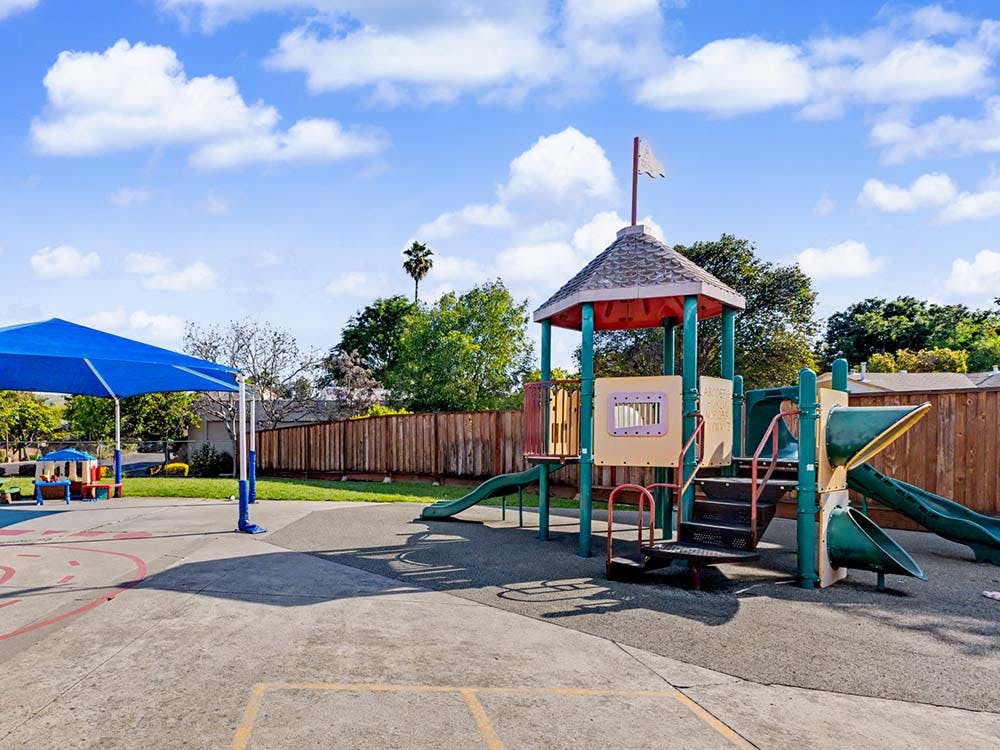 A colorful outdoor playground with slides and climbing structures