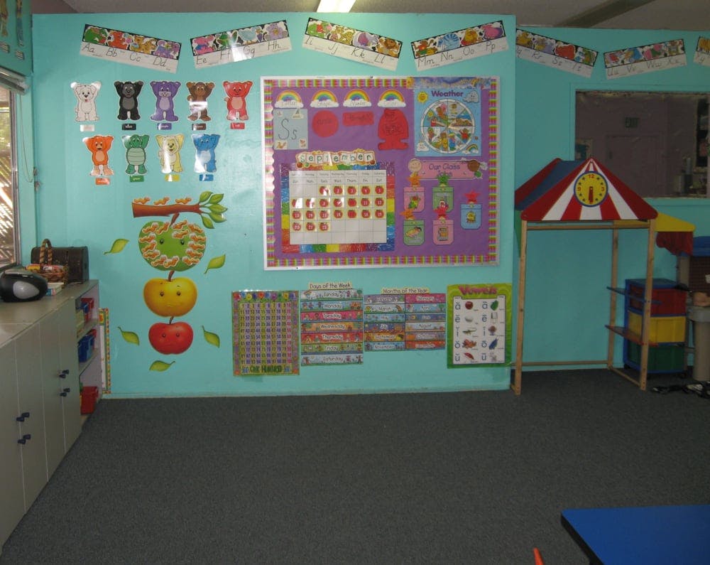 Classroom with educational posters and a small play tent