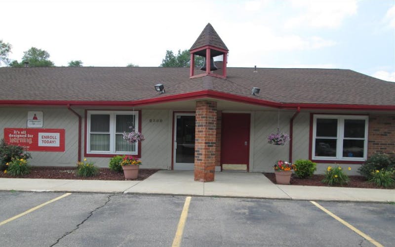 Entrance of a building with a red sign that says "Enroll Today!"