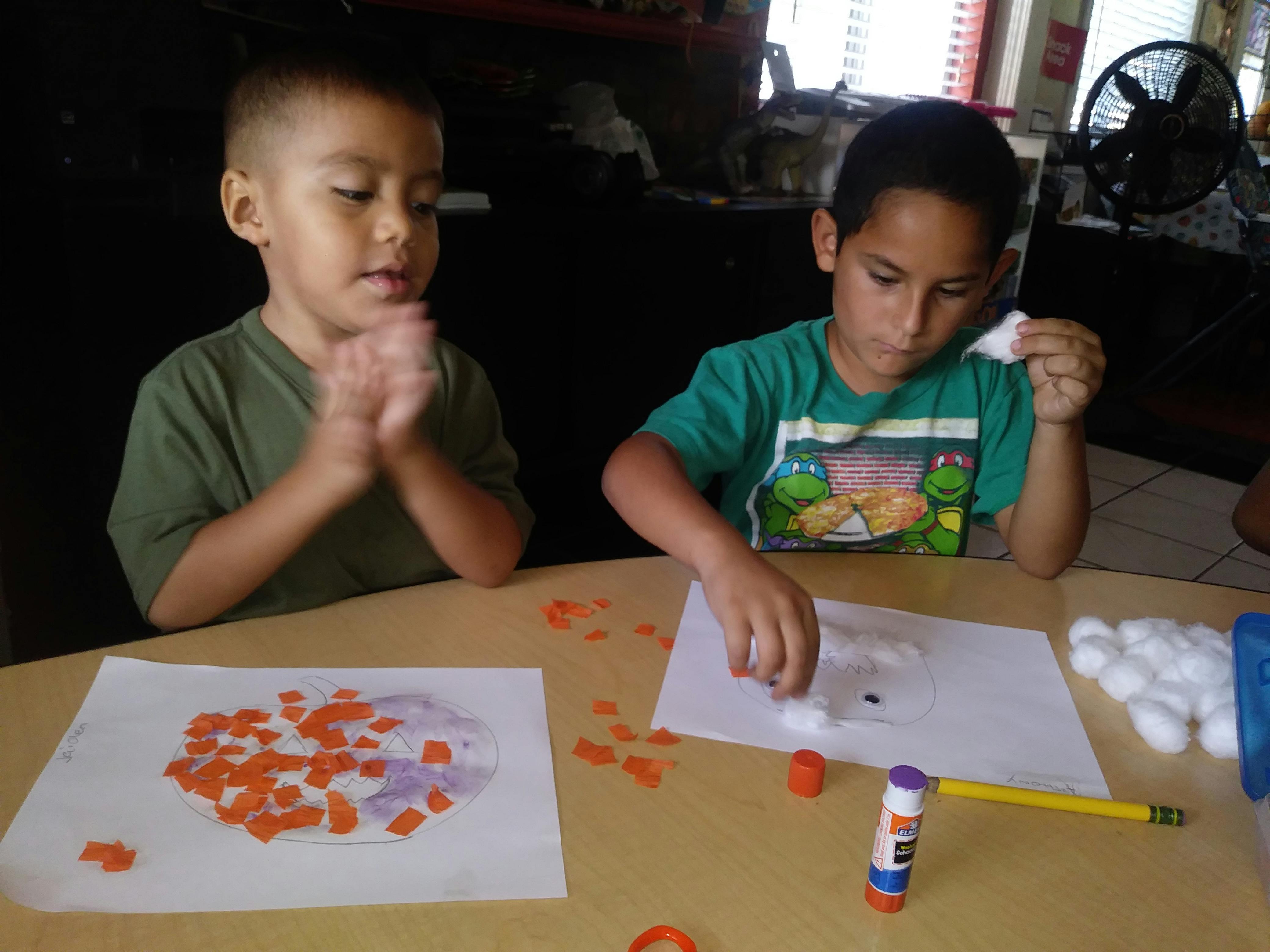 Two children doing crafts at a table