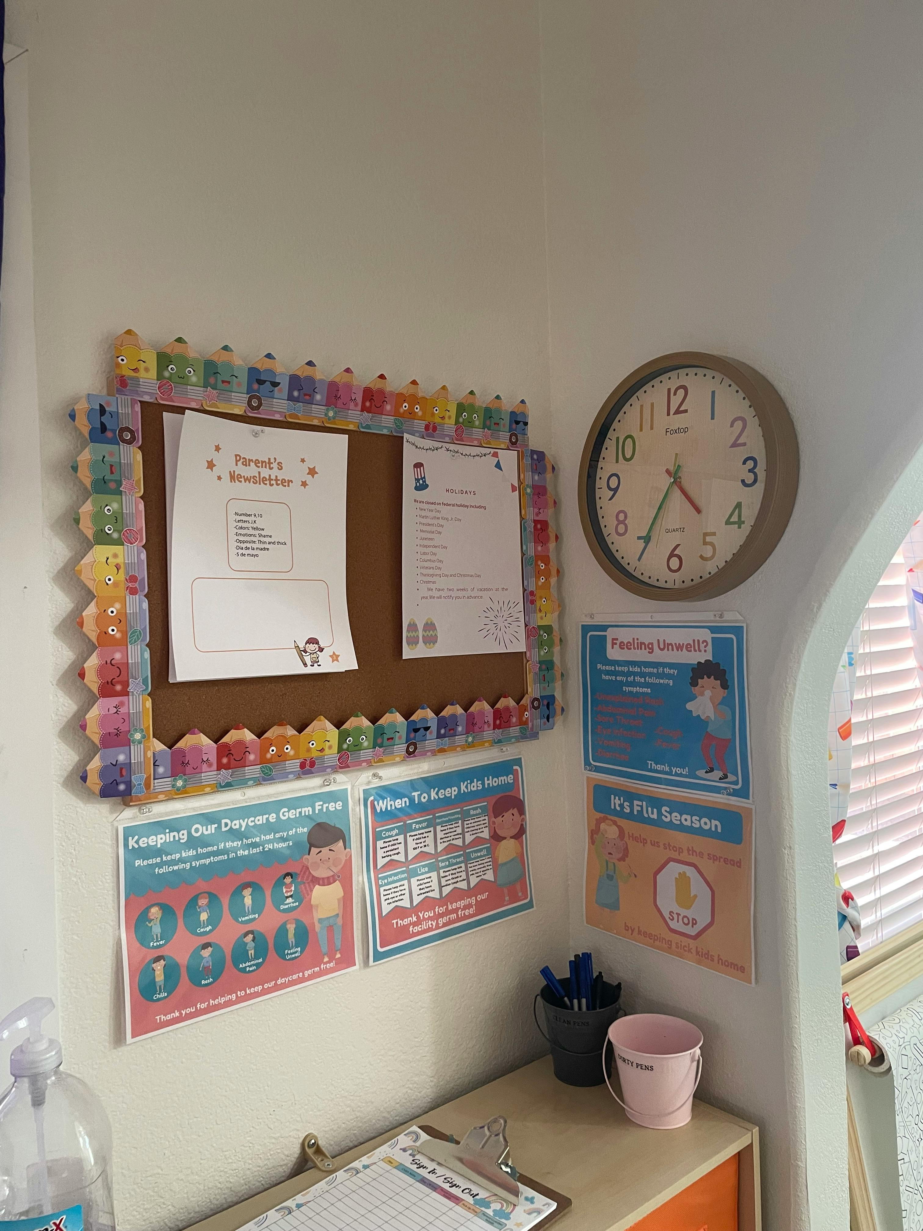 Bulletin board with papers, clock, and health posters on a wall