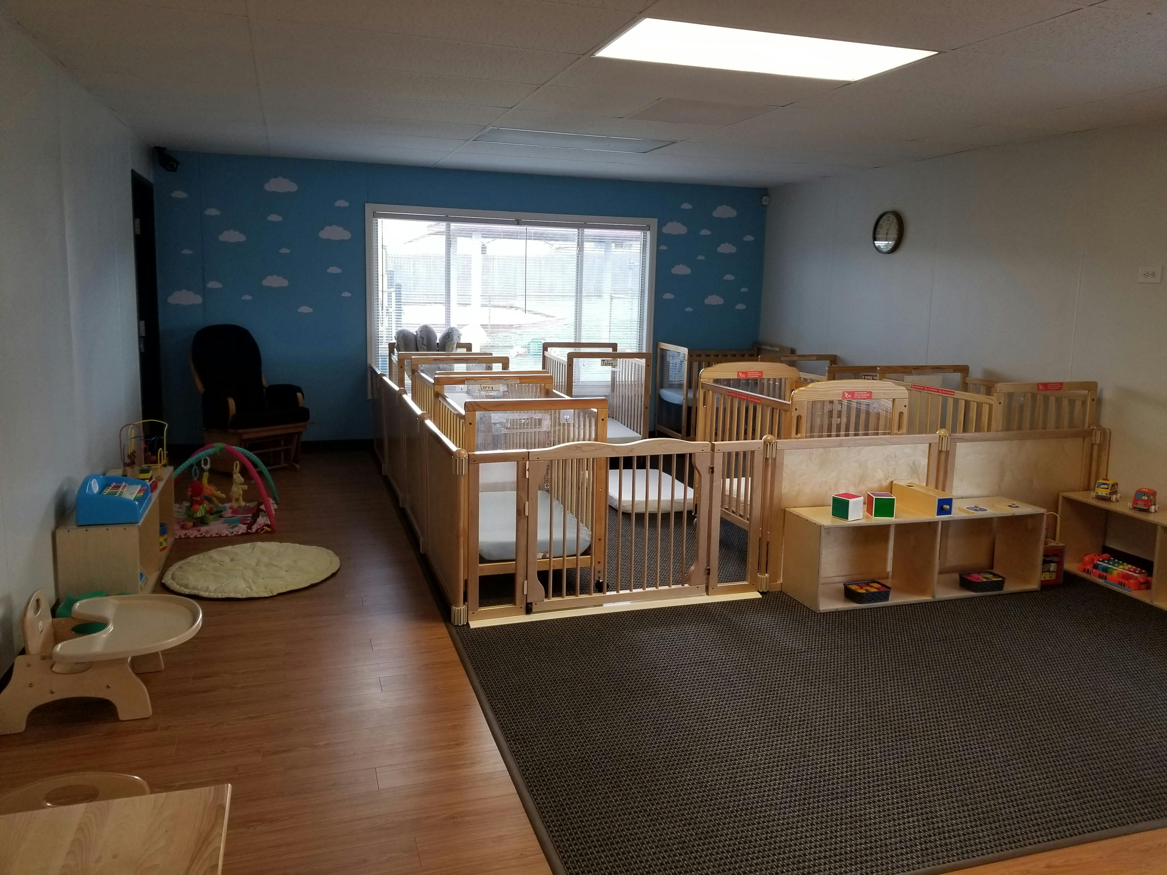 Nursery room with multiple cribs and play area