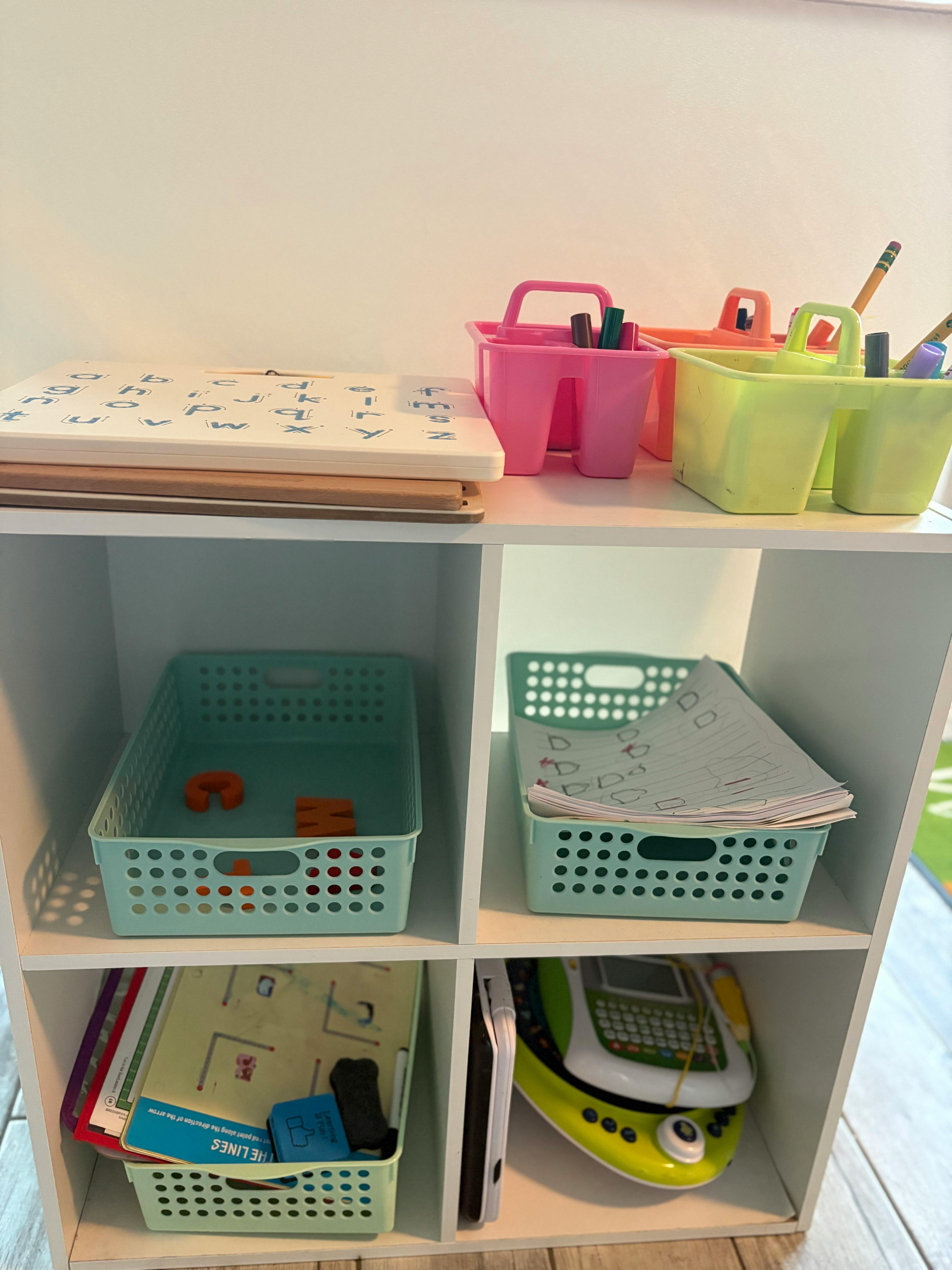 White shelving unit with colorful bins and school supplies