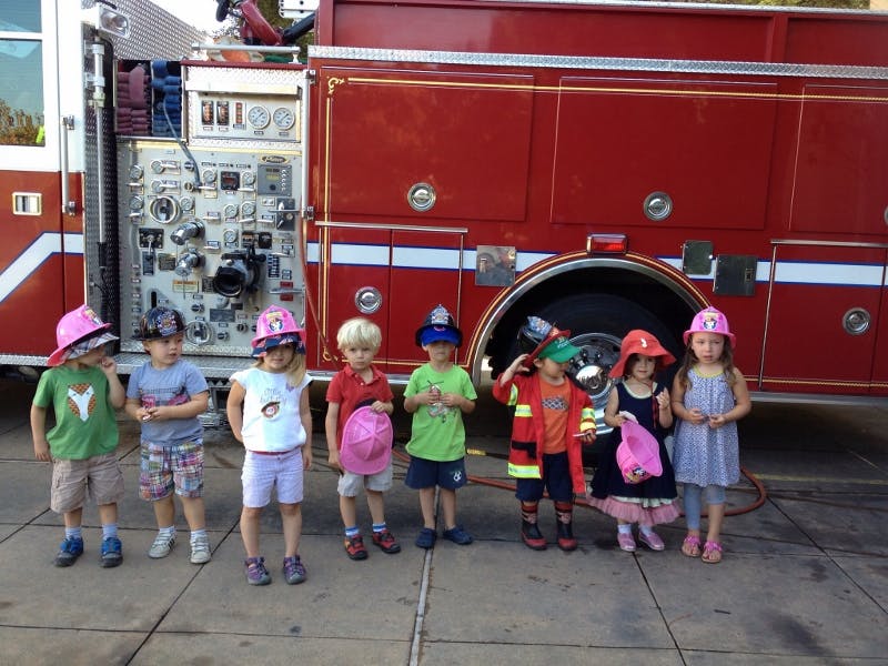 Group of children in front of a fire truck