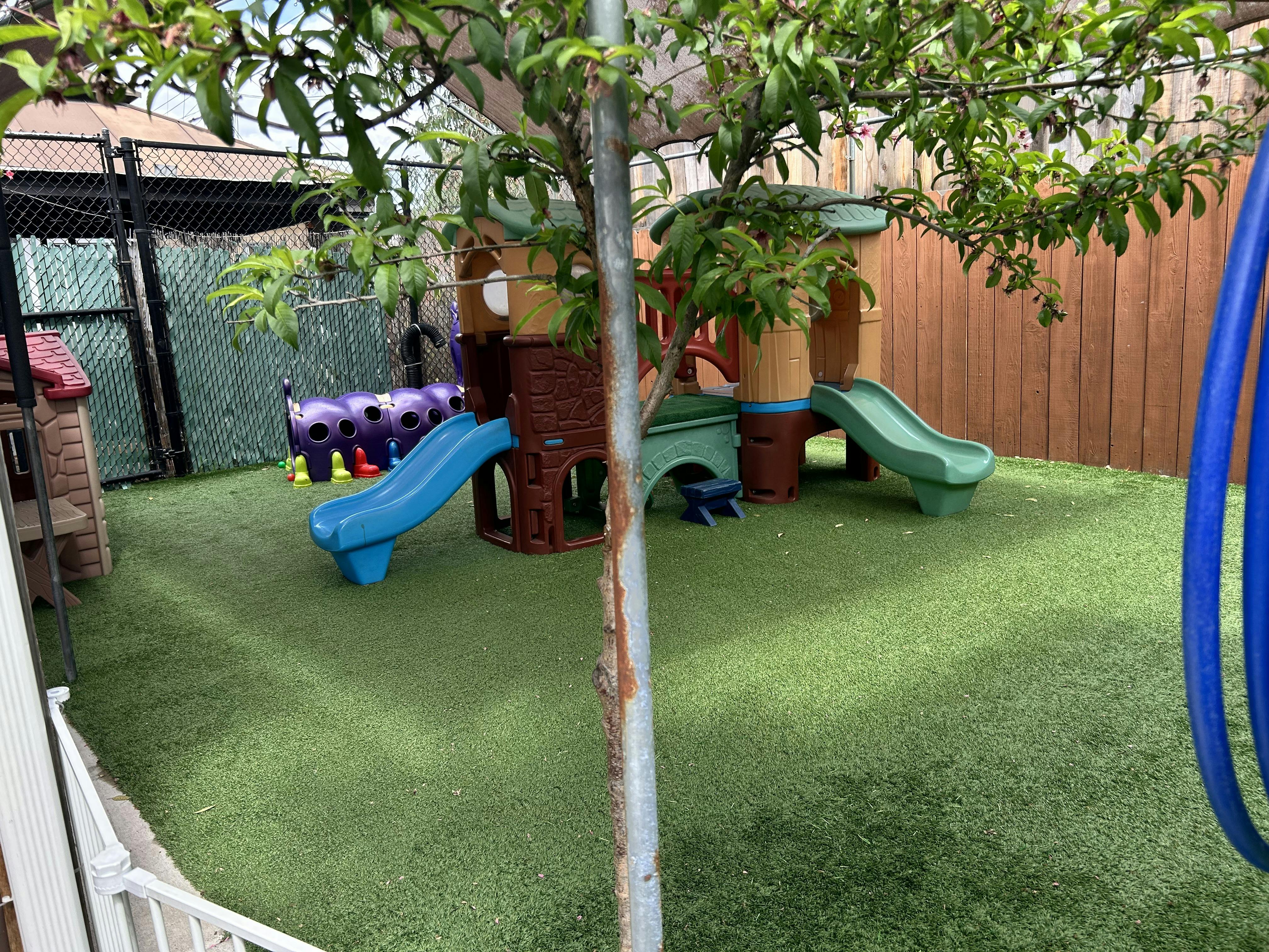 Playground with slides and climbing structures on artificial turf