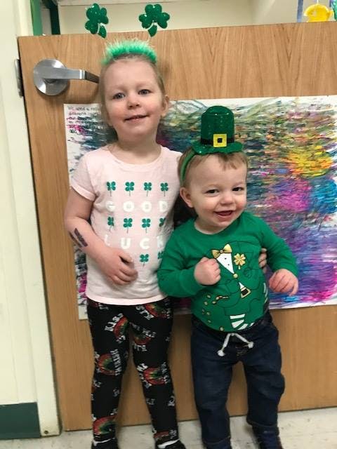 Child and baby in St. Patrick's Day themed clothing