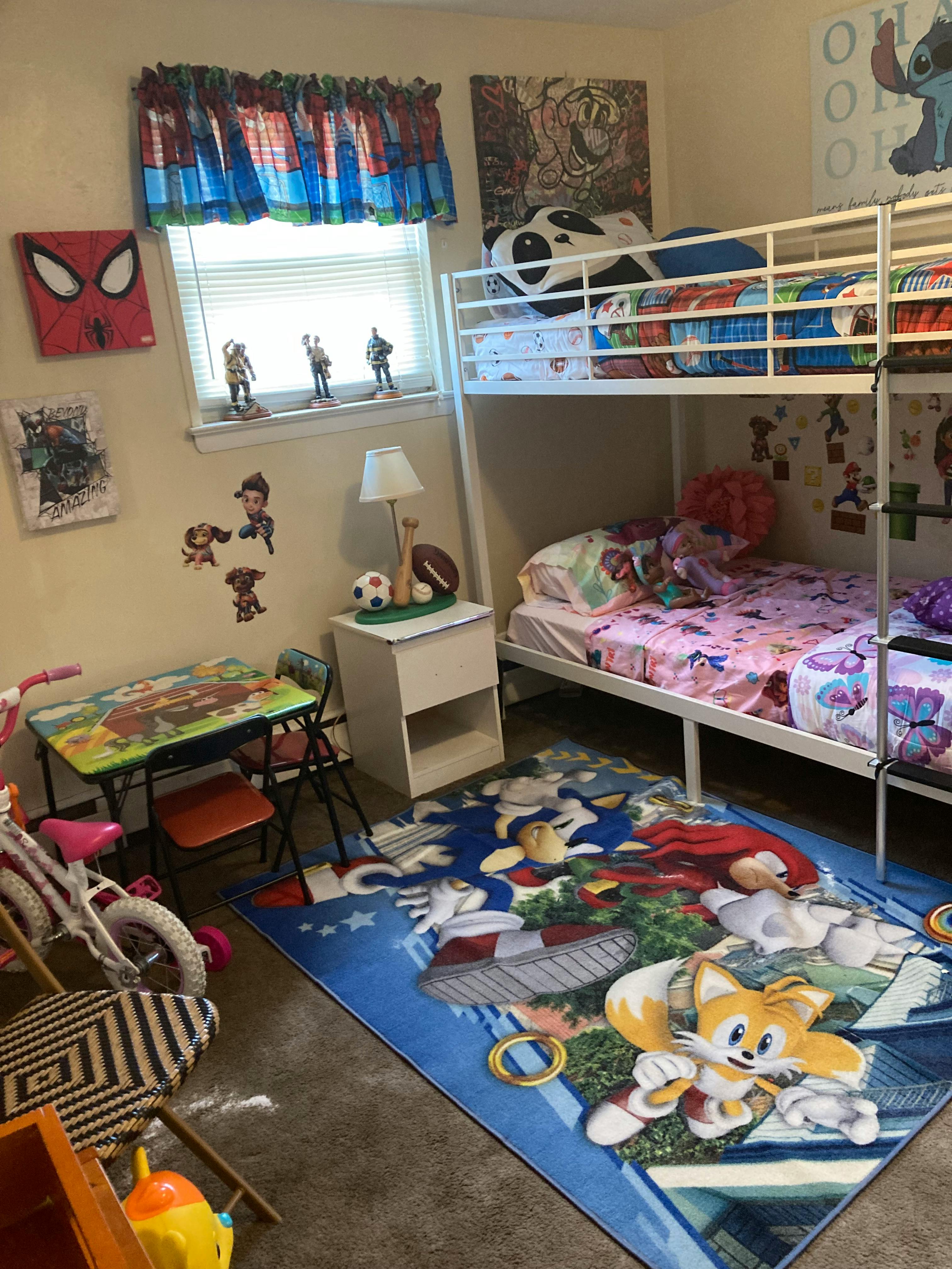 bunk beds in a child's bedroom with a Sonic the Hedgehog rug