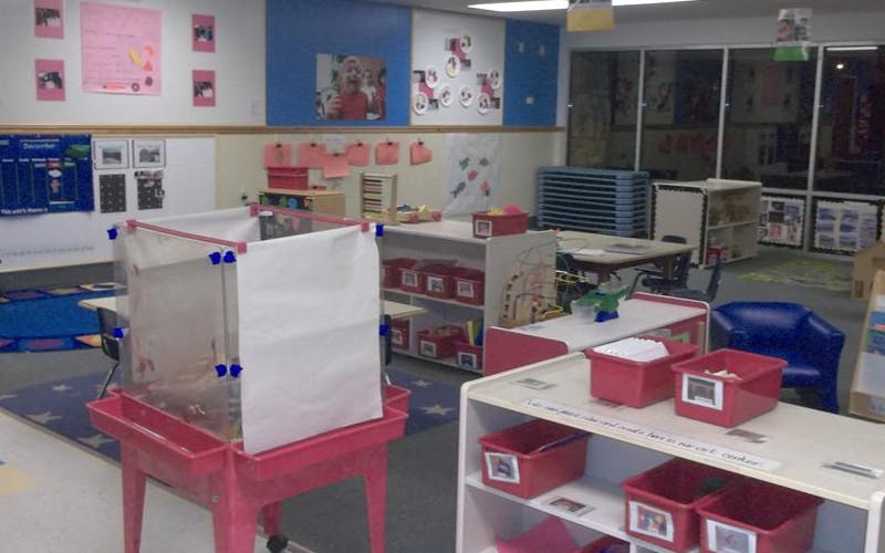 Classroom with child-sized furniture and art on the walls