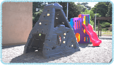 Playground with climbing structure and slide
