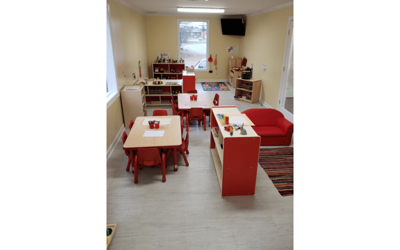 Empty classroom with small tables and chairs