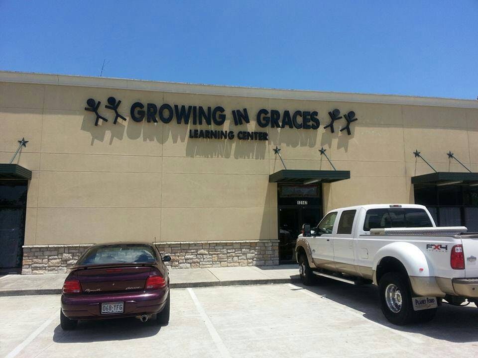 Building with "Growing in Graces Learning Center" sign and parked vehicles