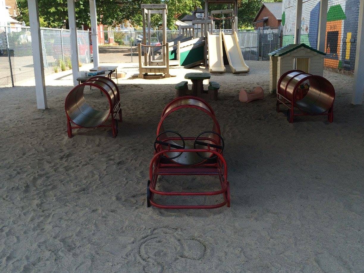 Playground with red tunnel climbers and slides