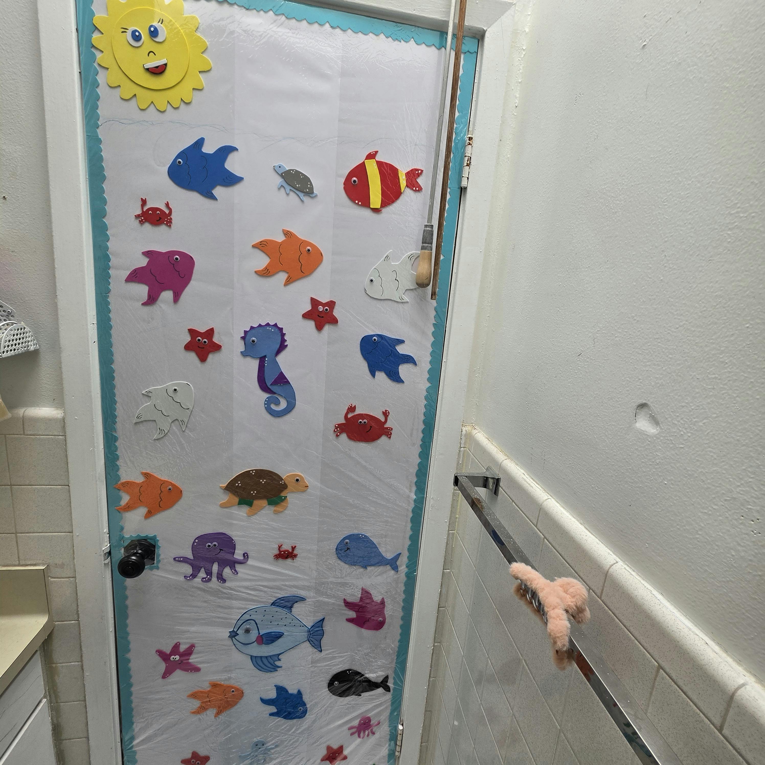 Decorative shower curtain with a sun and various sea creatures