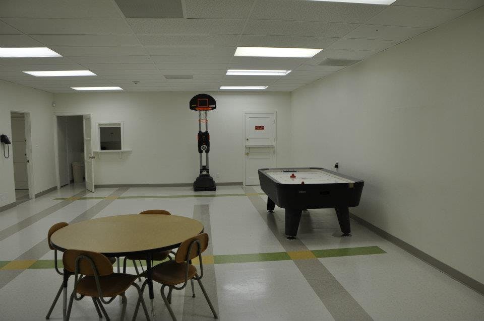 Game room with a pool table, basketball arcade game, and round table with chairs