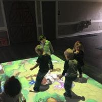 Children playing on an interactive floor projection