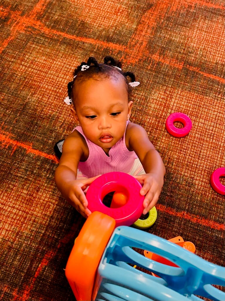 Child playing with colorful stacking rings