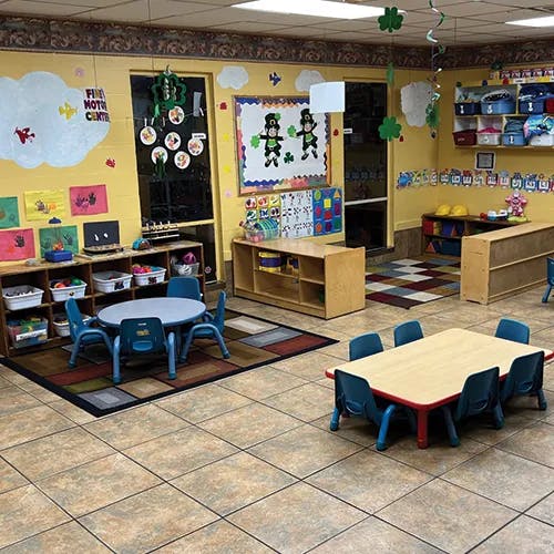Empty classroom with small tables and chairs