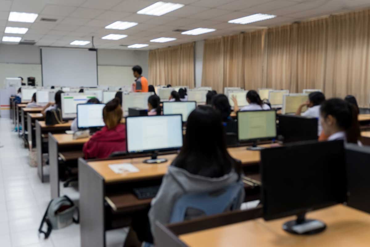 People in a computer lab with monitors on desks