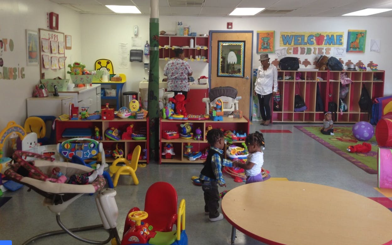 Two children playing in a room with toys and shelves