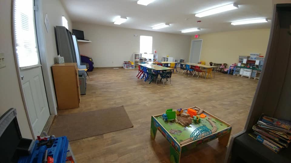 Empty classroom with small tables and chairs