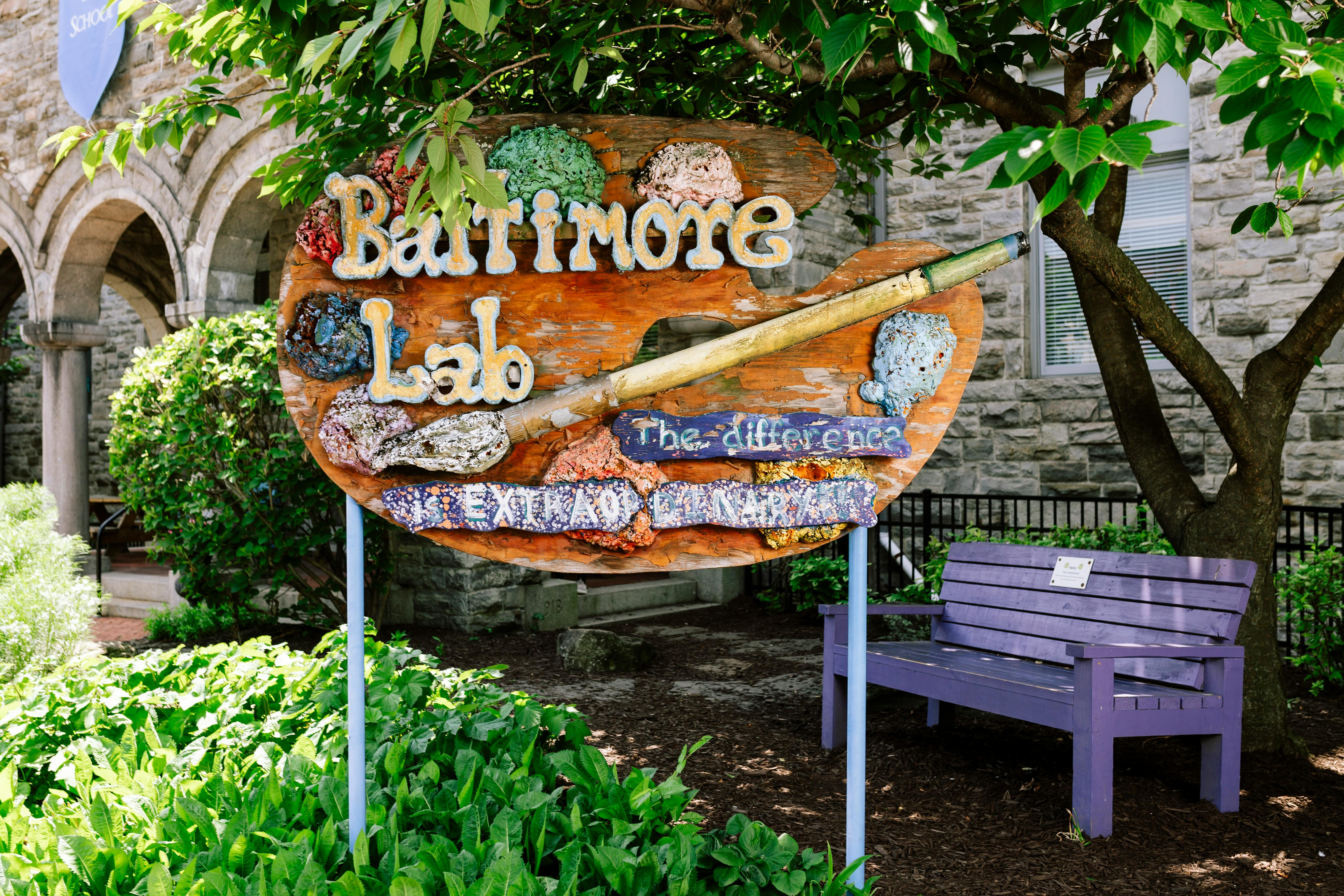 Sign shaped like a painter's palette with "Baltimore Lab" and a paintbrush
