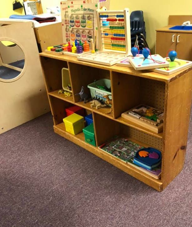 Wooden shelf with various toys and learning materials