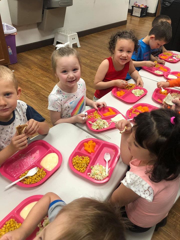 Children eating meals at a table