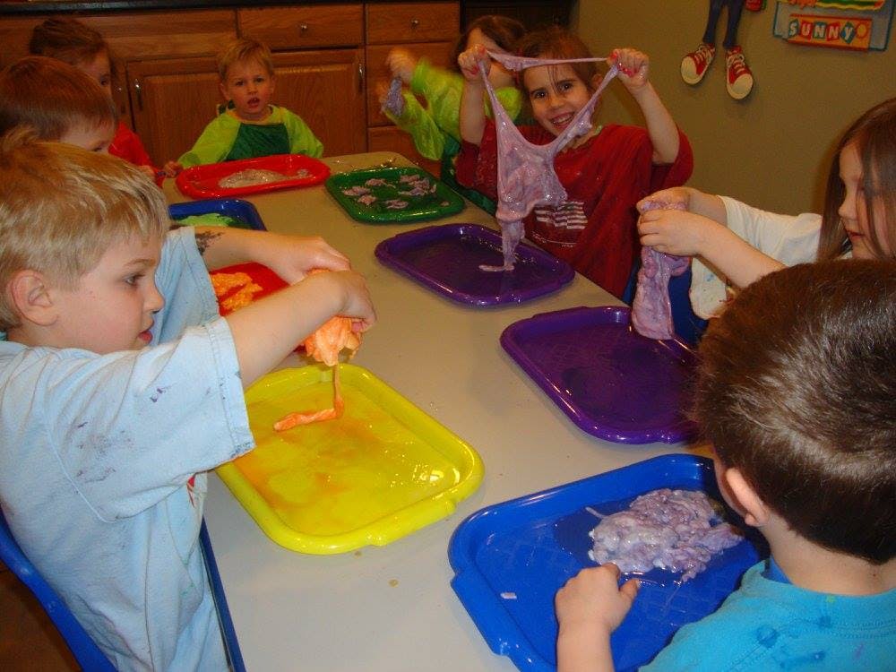 Children playing with slime at a table