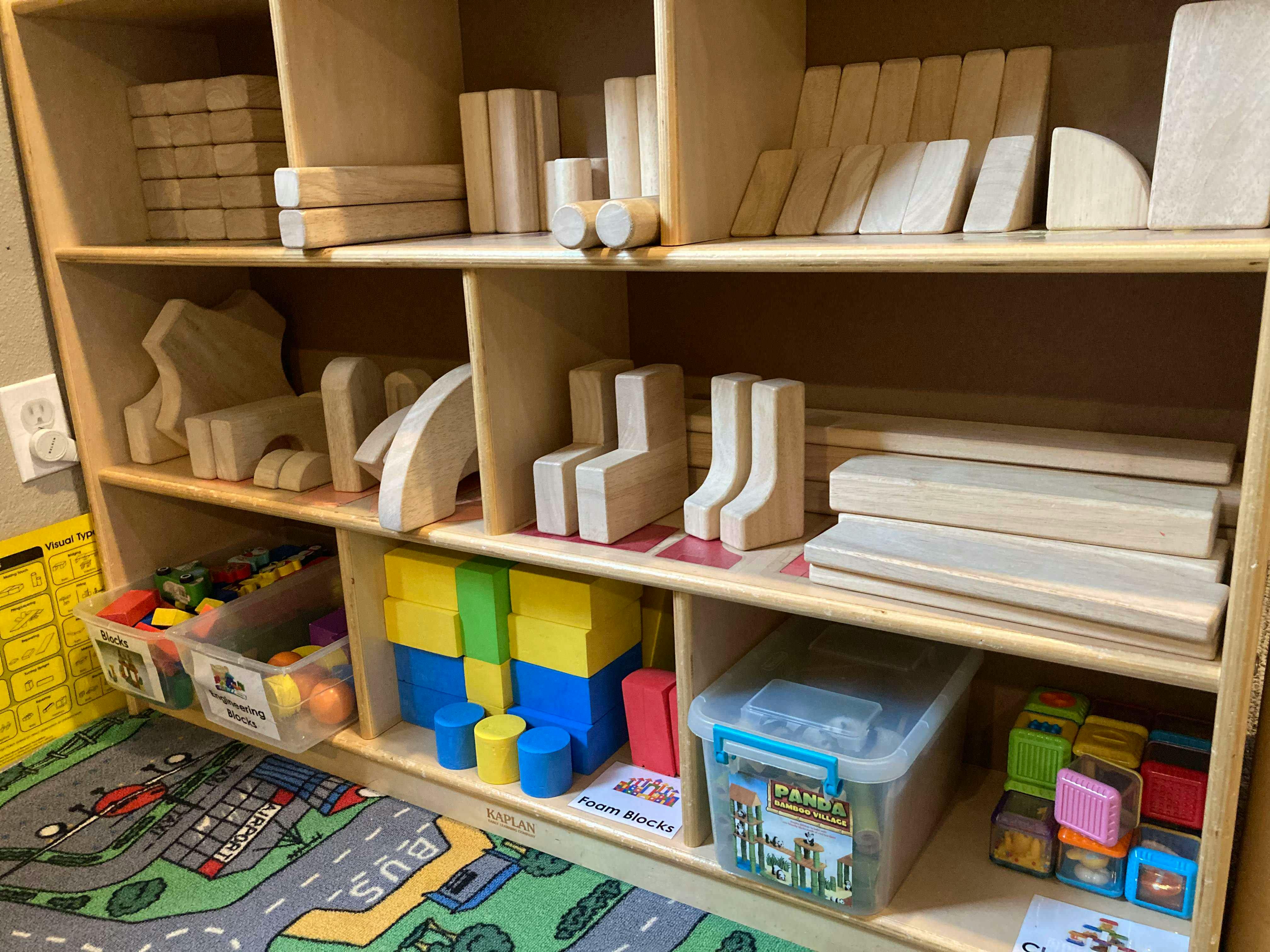 Wooden shelves with various wooden blocks and colorful toys
