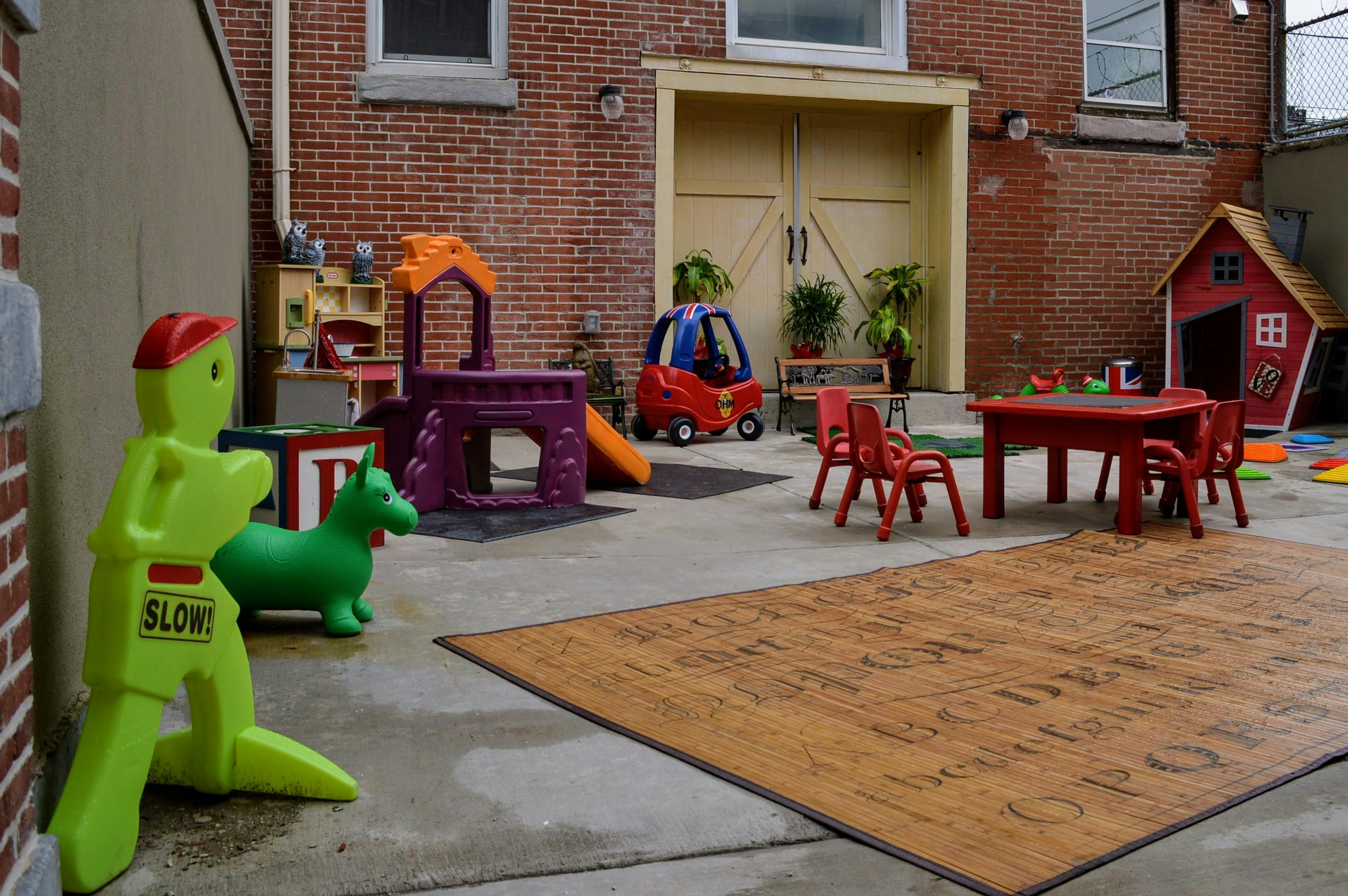 Outdoor play area with various toys and furniture