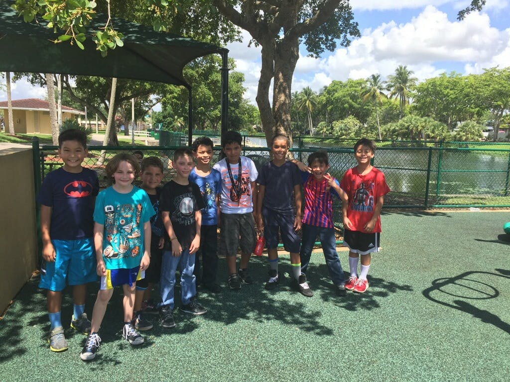 Group of children standing outdoors on a sunny day