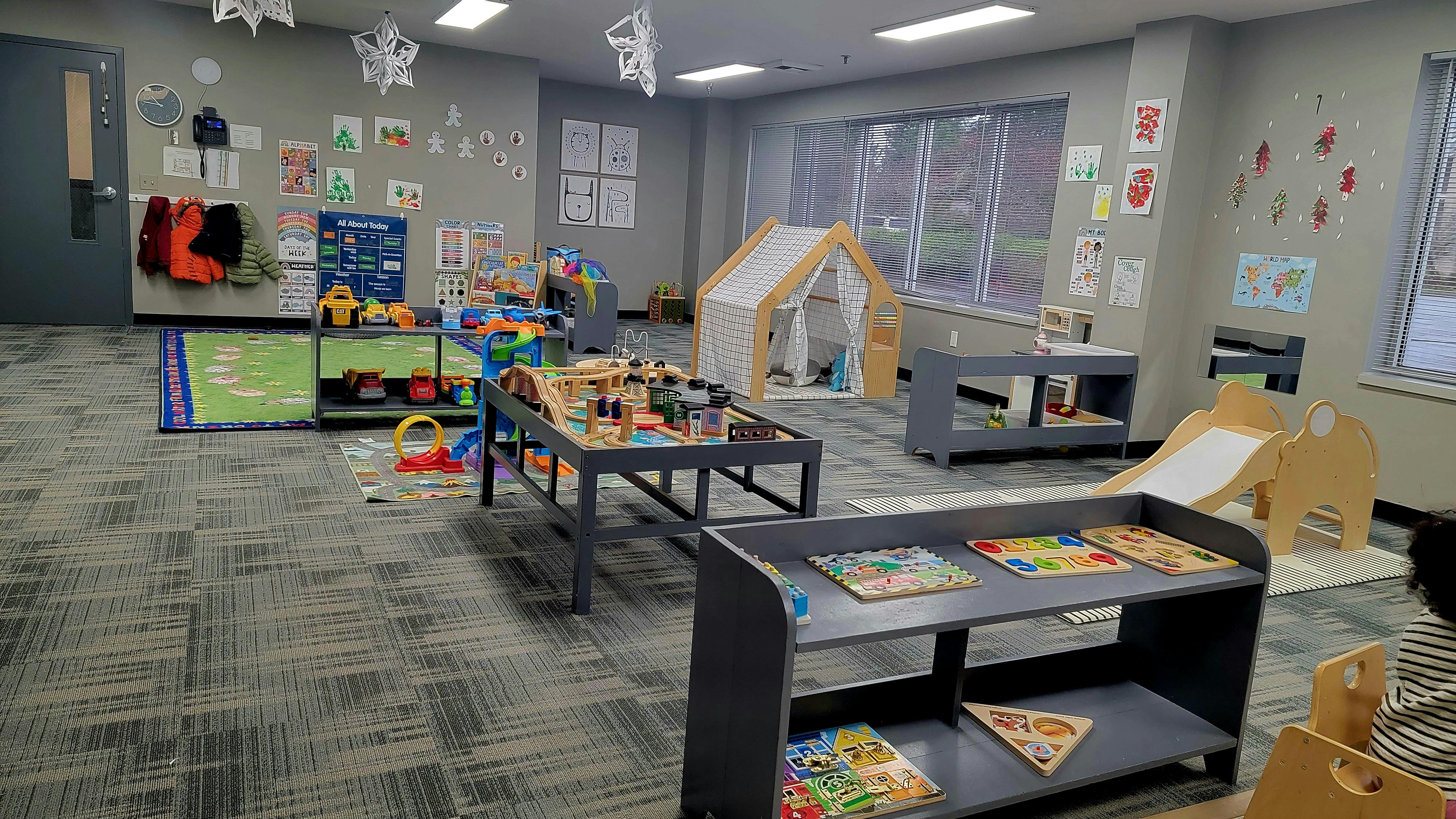 Playroom with various toys, a small slide, and a tent