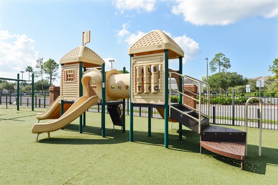 Playground with slides and climbing structures on green turf