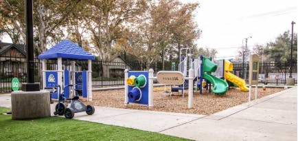 Playground with blue, green, and yellow play structures