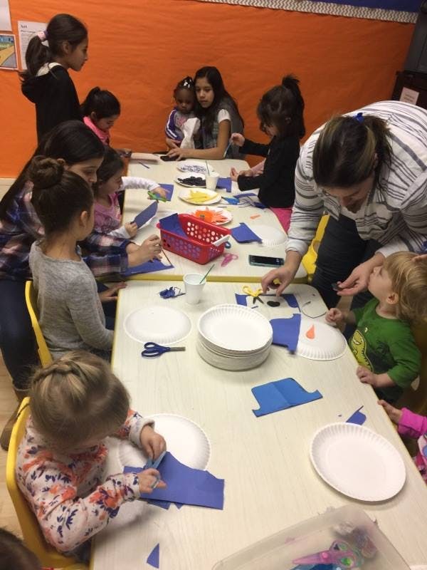 People and children doing crafts at a table