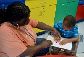 Adult and child doing an activity together at a table
