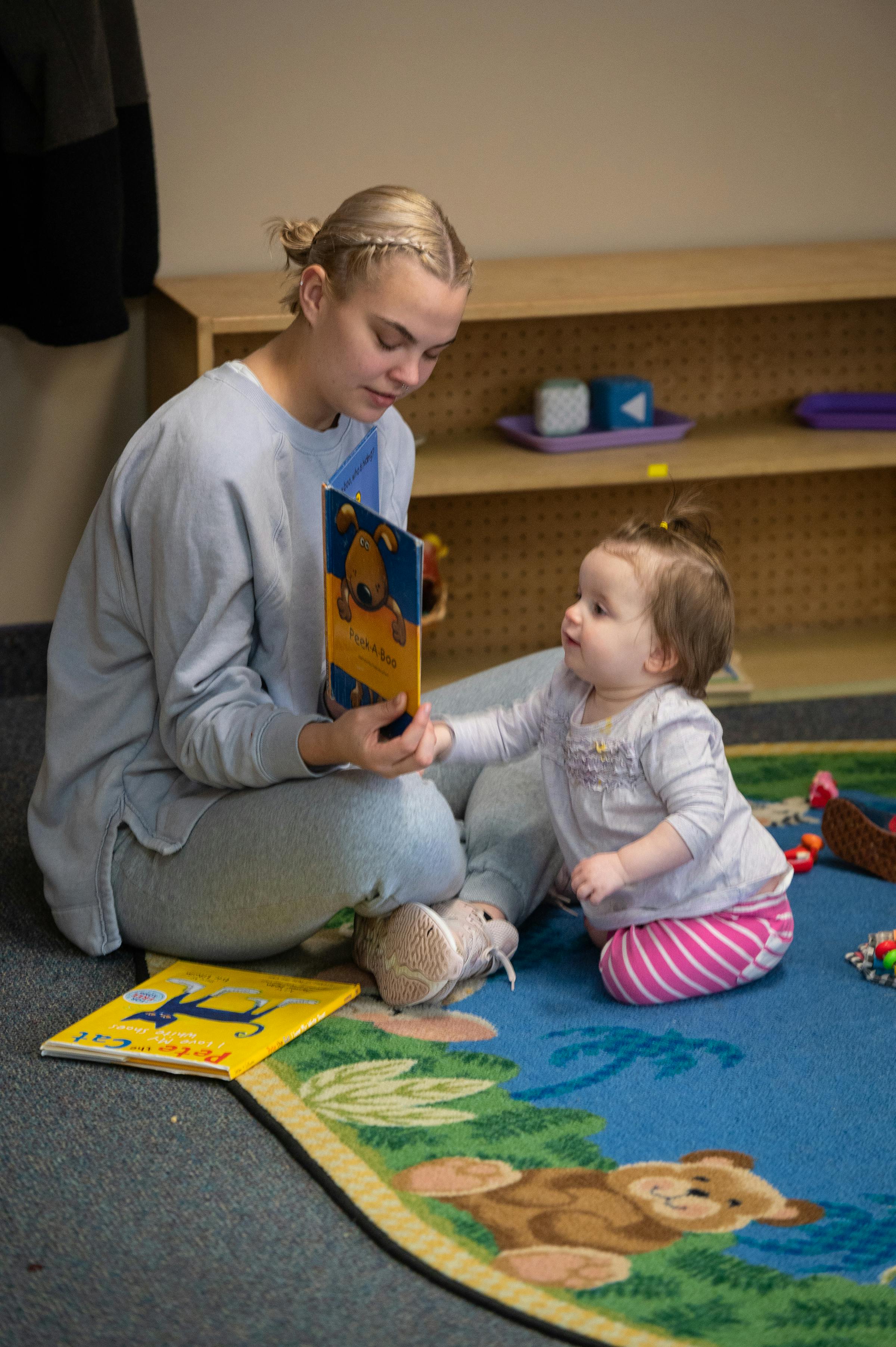 Person reading a book to a child