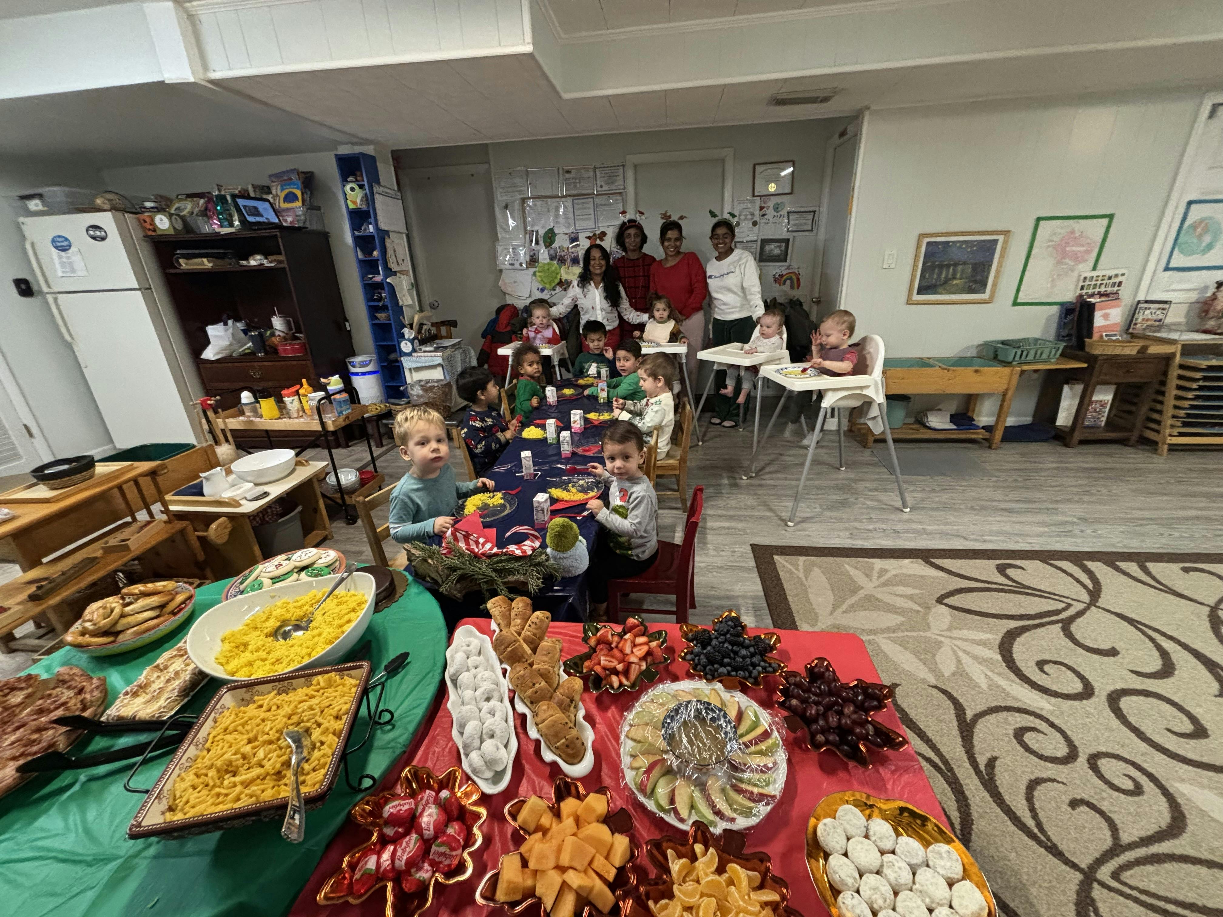 Children and adults gathered around tables with food
