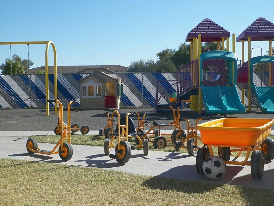 Playground with various ride-on toys, swings, and slides