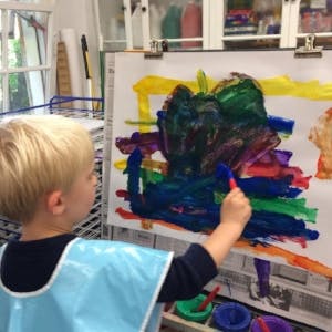 Child painting on an easel