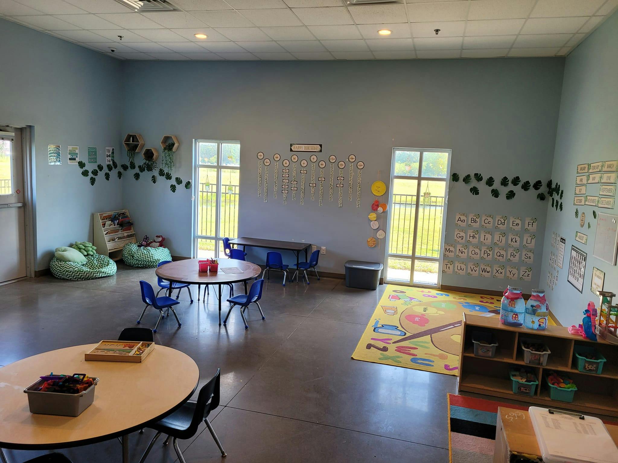 Empty classroom with tables, chairs, and beanbag seats