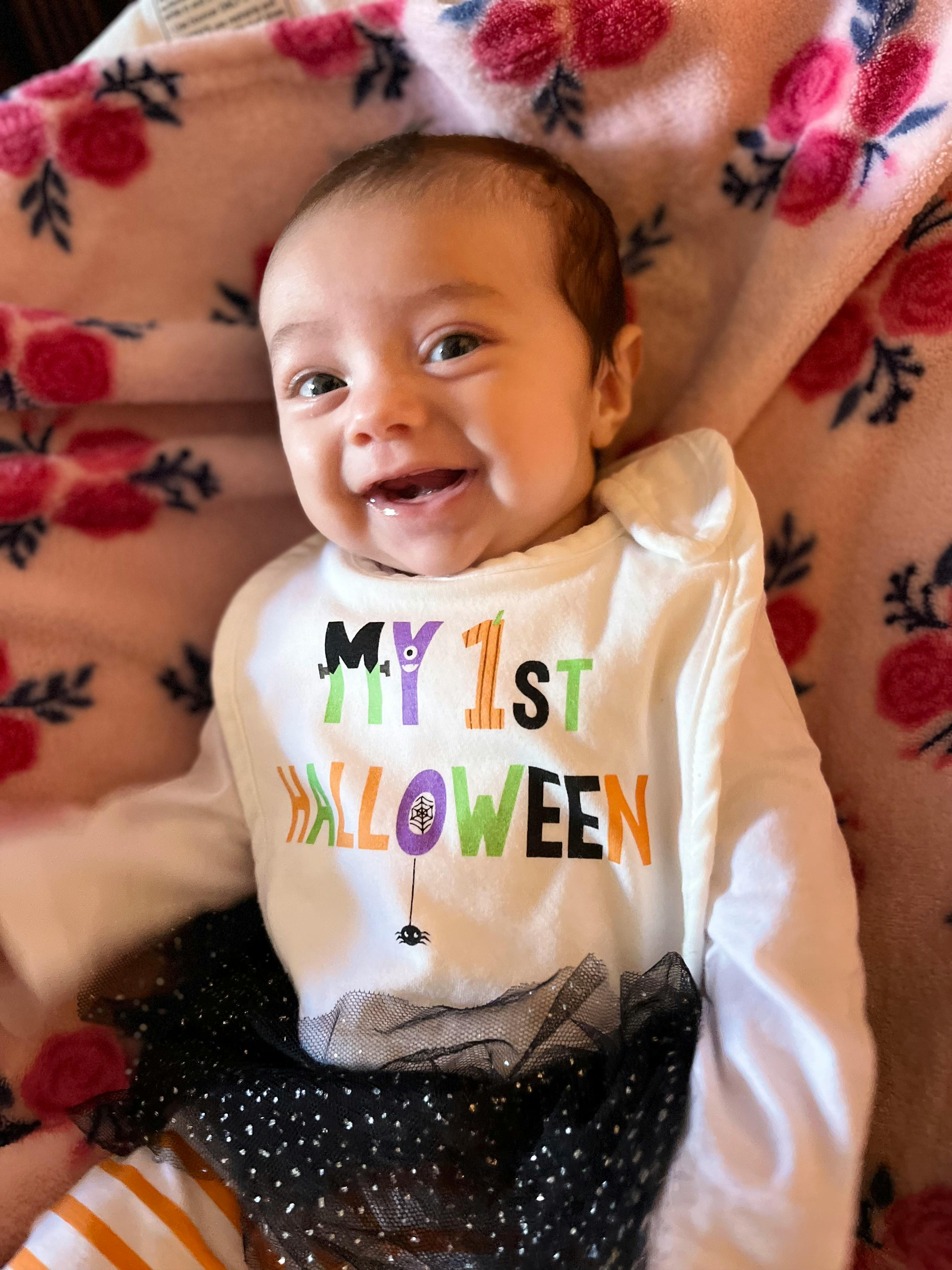 Child wearing a "My 1st Halloween" shirt