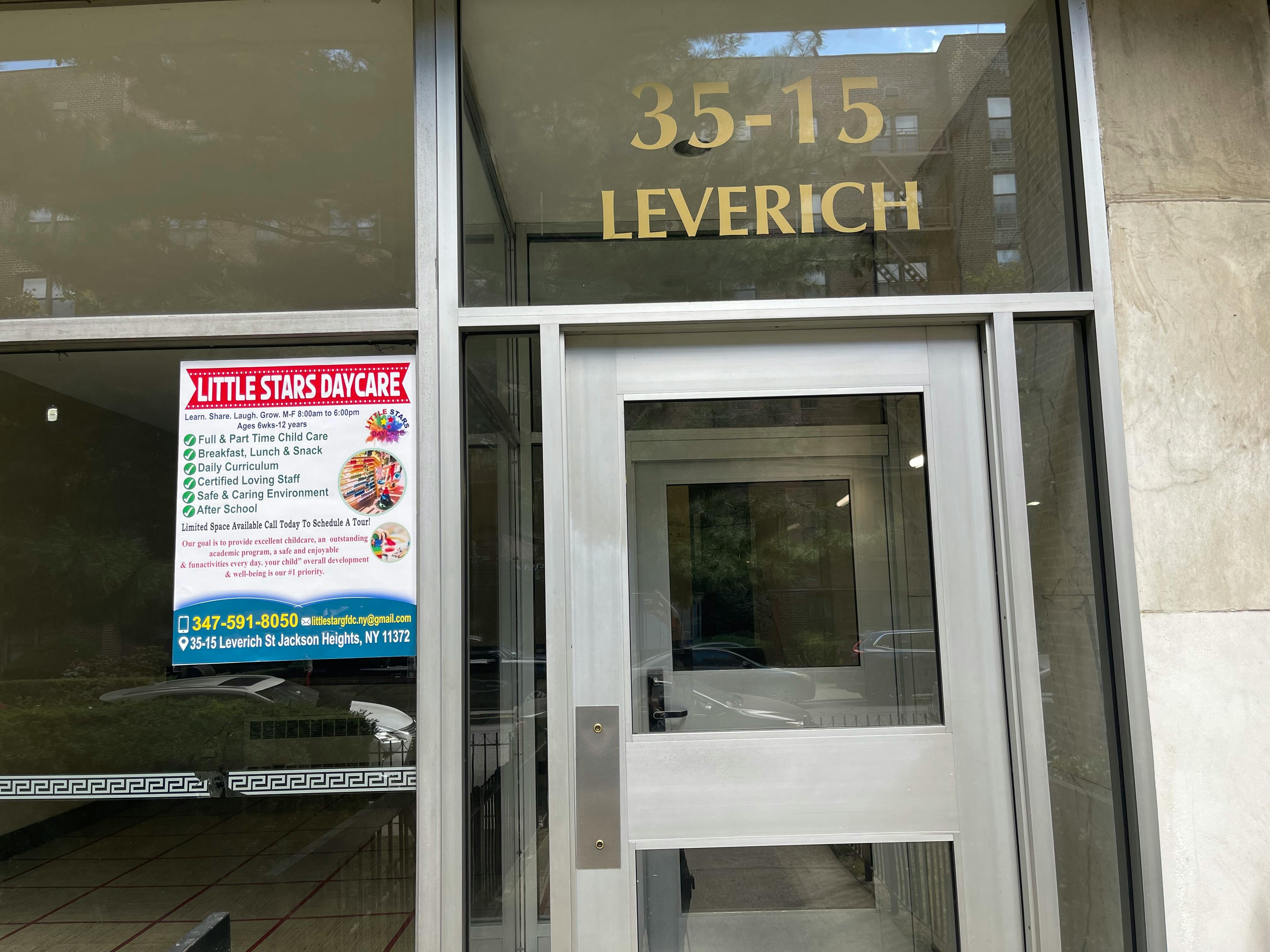 Daycare sign on a glass door with building numbers 35-15 Leverich