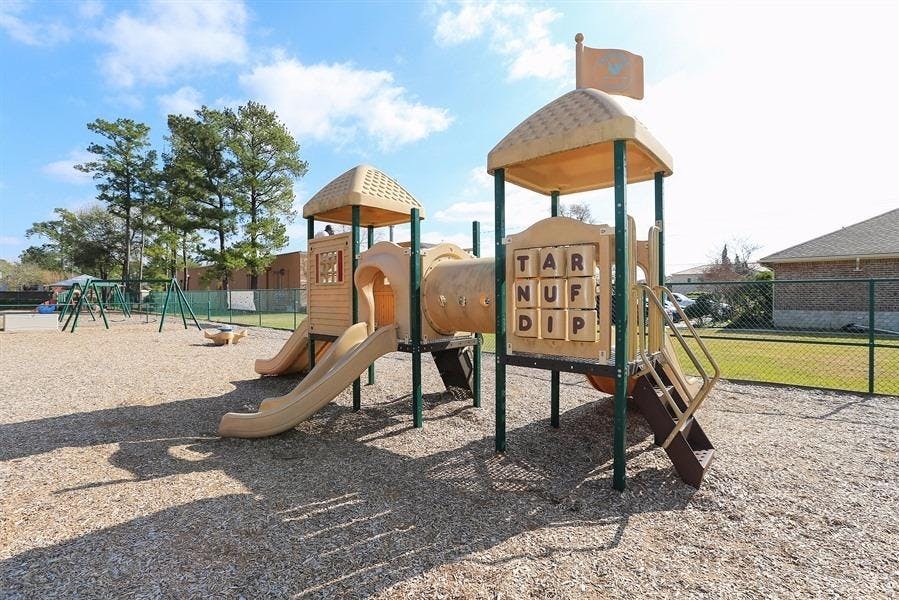 Empty playground with slides, tunnels, and swings