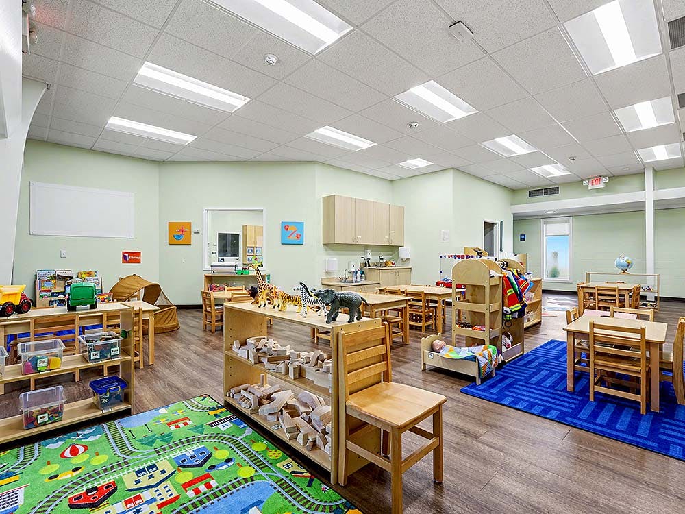 Classroom with child-sized furniture and toys arranged throughout