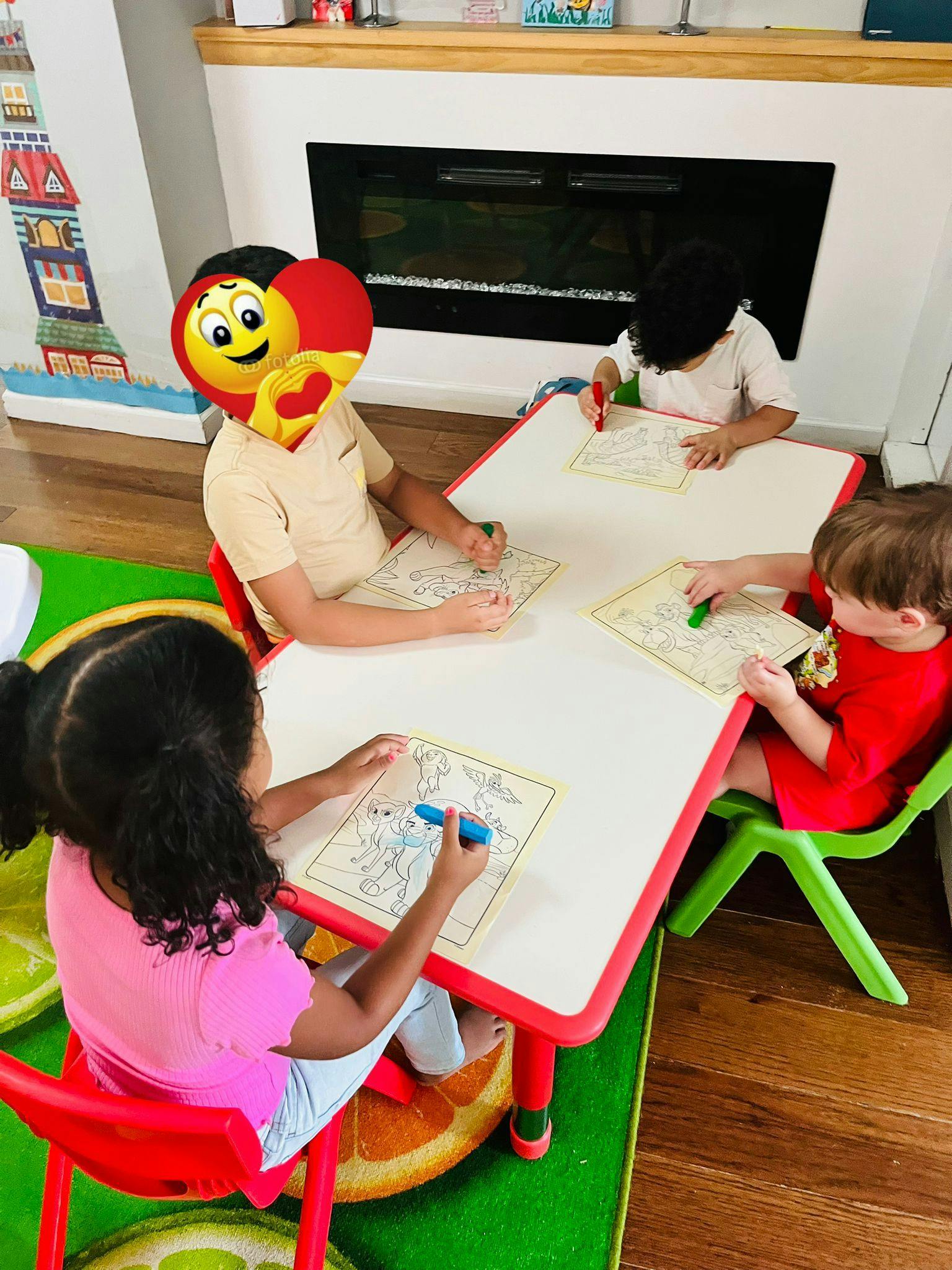 Four children coloring at a table